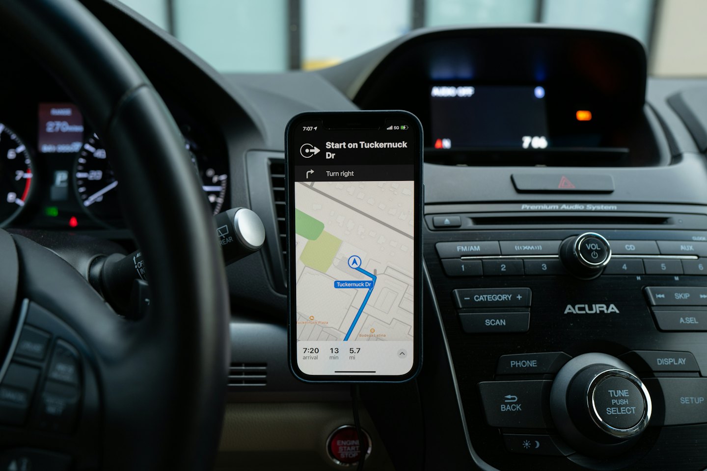 Smartphone showing navigation mounted on a car dashboard.
