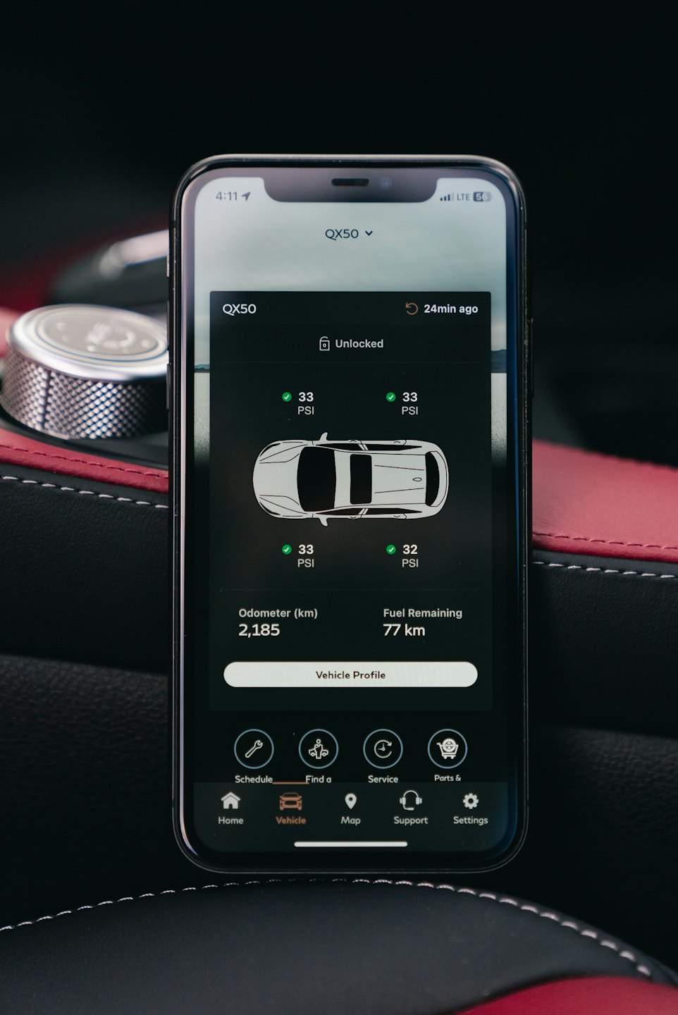 Smartphone app showing vehicle diagnostic data inside a car.